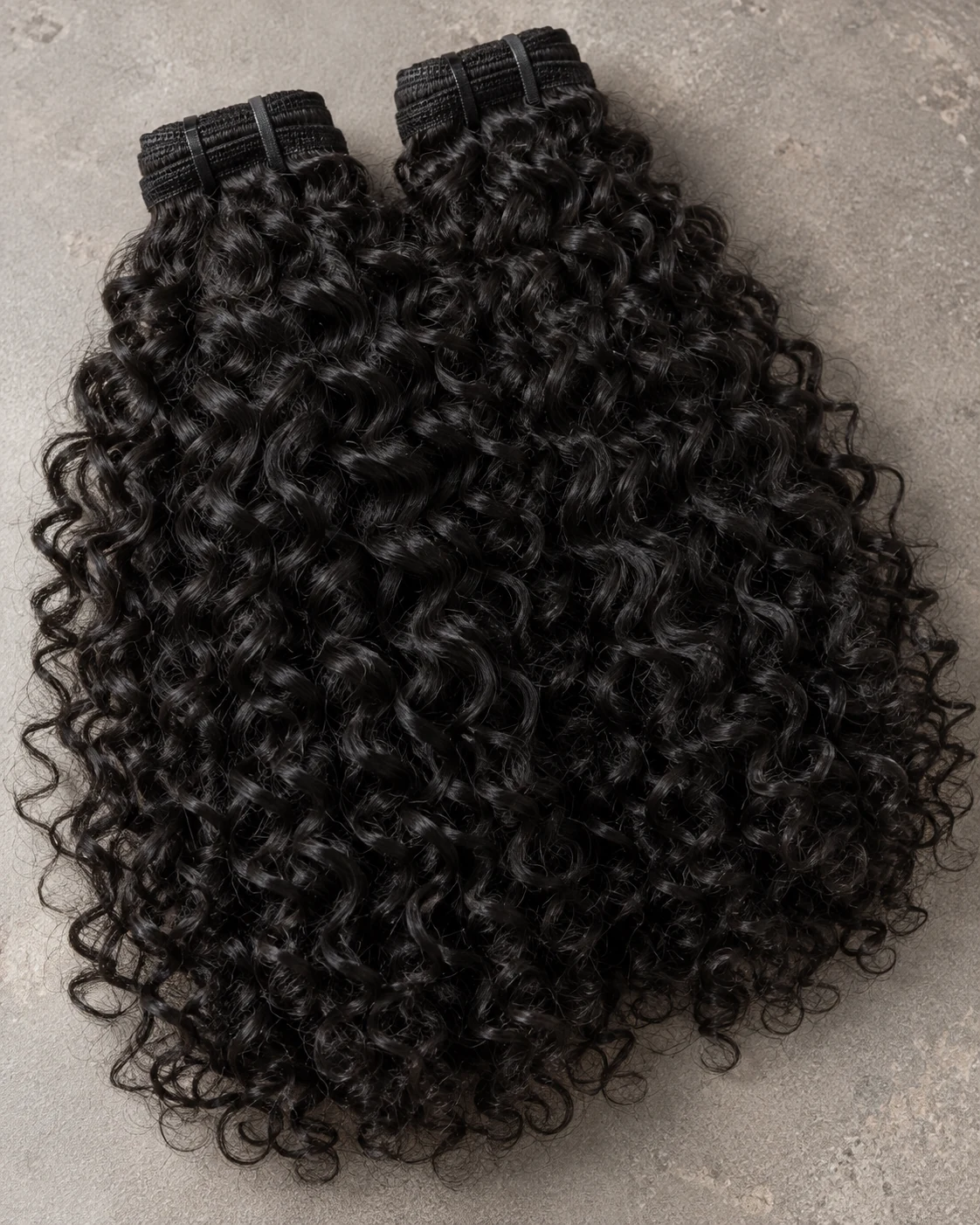 Illustrative black curly hair bundles showing springy texture